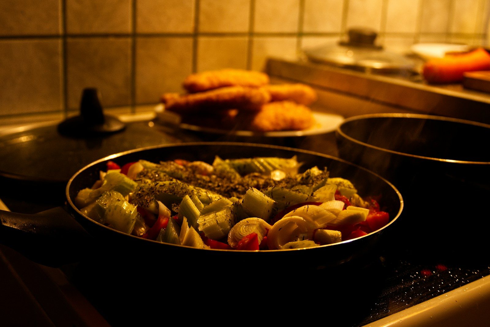Fresh vegetables cooking in a pan on stove.