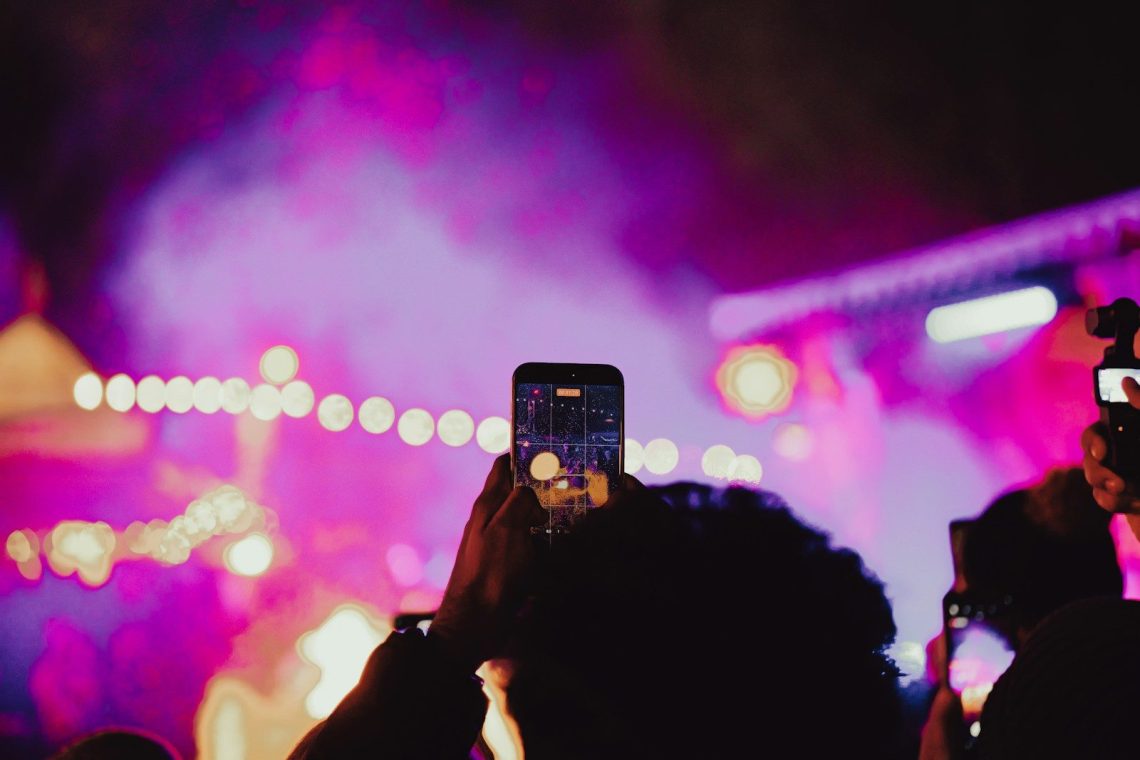 People recording a concert with their phones