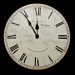 A round wall clock with a cracked white face and black Roman numerals